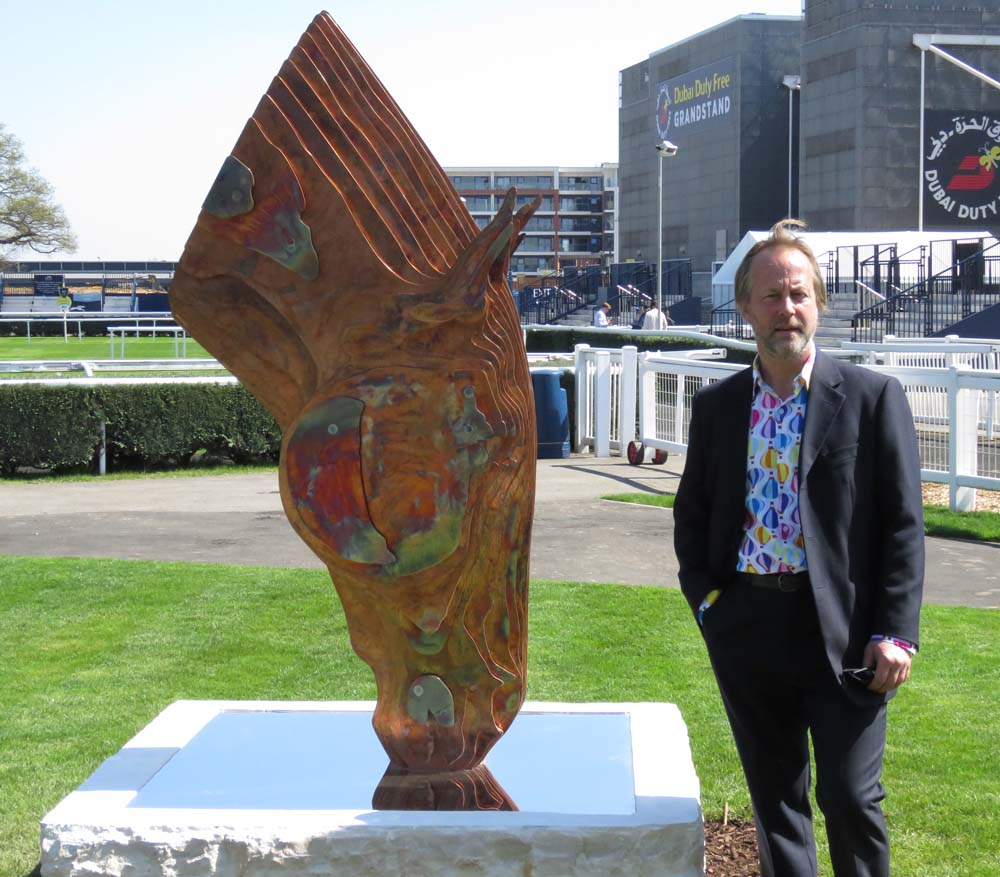 Tom Hiscocks stands beside his Drinking Horse 